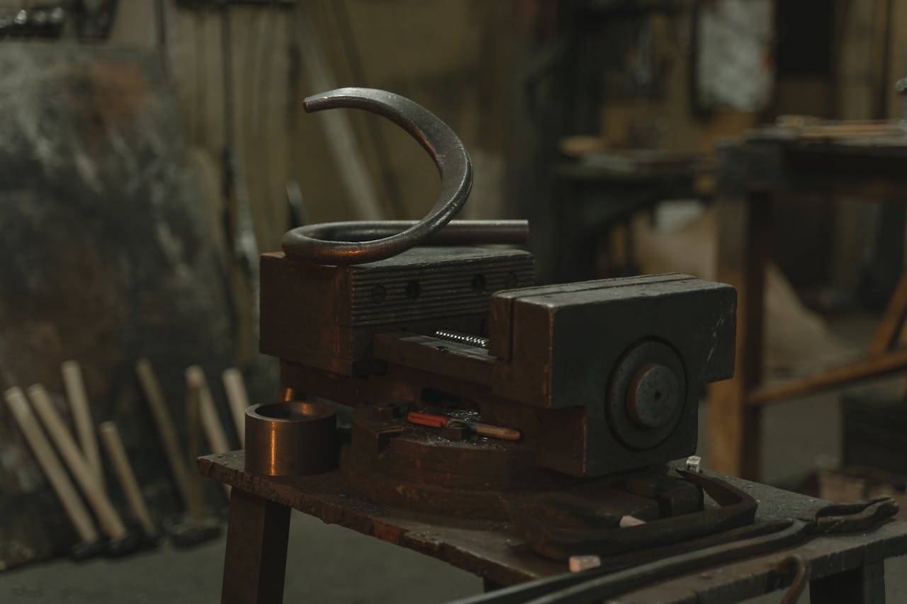 heros-img Close-up of metalwork equipment in an industrial workshop setting.